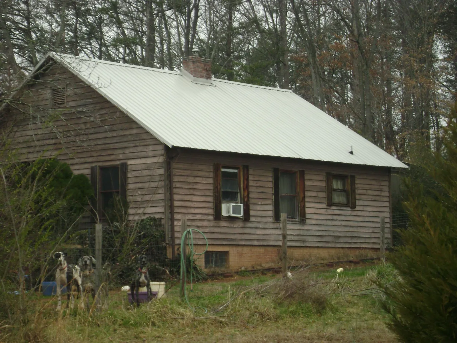 White metal roof on an old wood sided farmhouse, from a Metal Roof Installation job in Gilberts